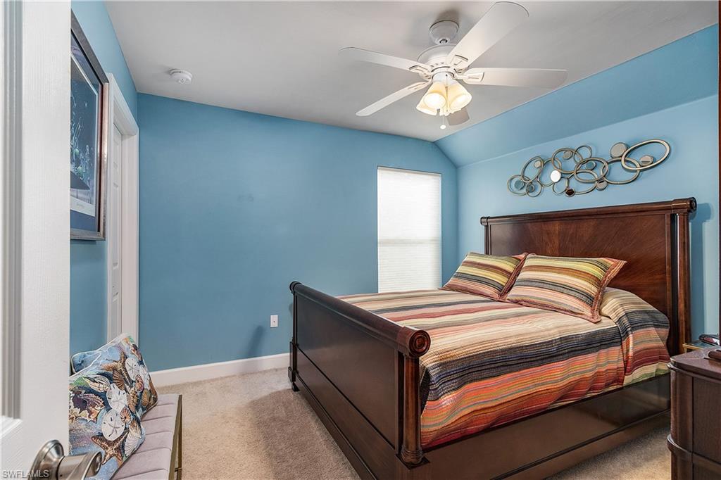 16309 Winfield Lane Naples, FL 34110 - Photo 17 of 35 a bedroom with a bed and a chandelier