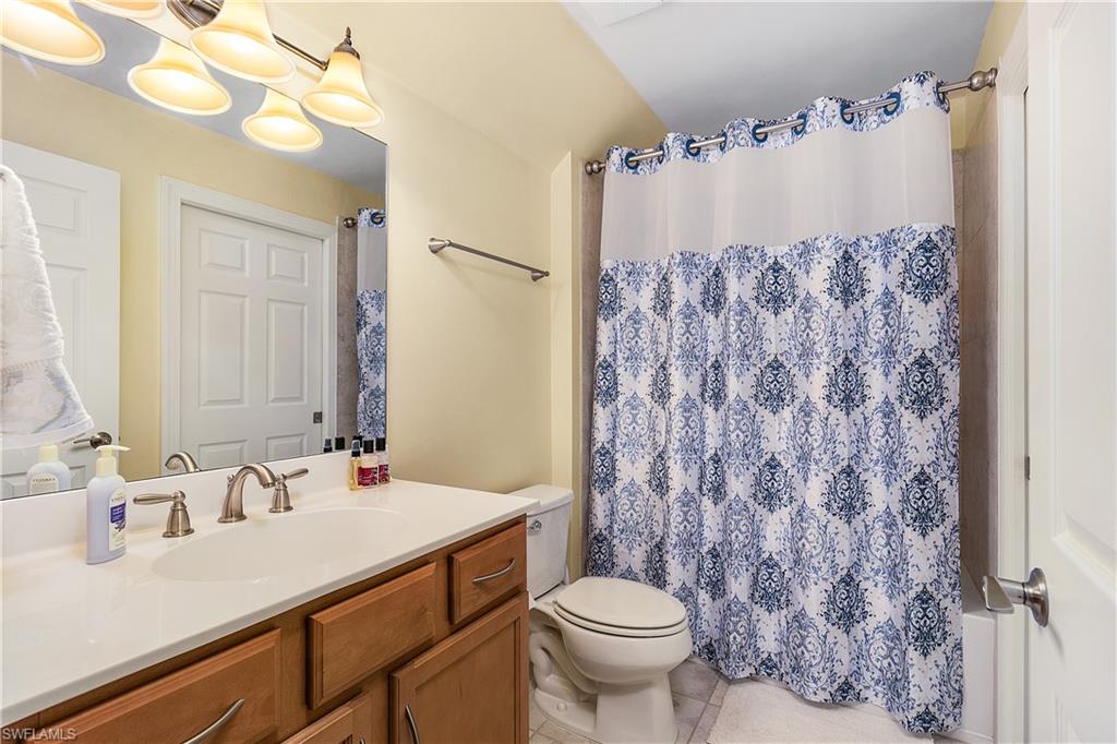 16309 Winfield Lane Naples, FL 34110 - Photo 18 of 35 a bathroom with a sink and a mirror