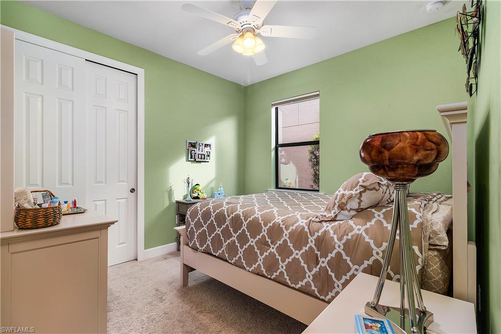 16309 Winfield Lane Naples, FL 34110 - Photo 26 of 35 a bedroom with a bed and a chandelier