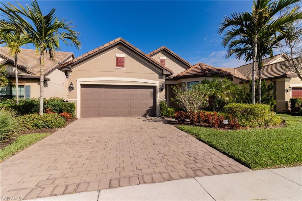 16309 Winfield Lane Naples, FL 34110 - Photo 3 of 35 a view of a house with a yard and potted plants
