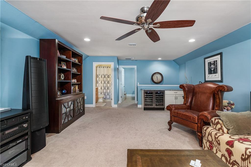 16309 Winfield Lane Naples, FL 34110 - Photo 31 of 35 a living room with furniture and a flat screen tv