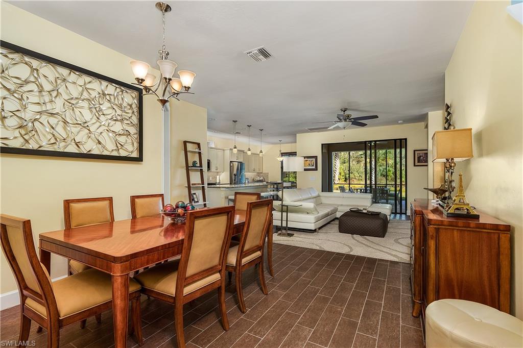 16309 Winfield Lane Naples, FL 34110 - Photo 7 of 35 a view of a dining room with furniture a chandelier and wooden floor