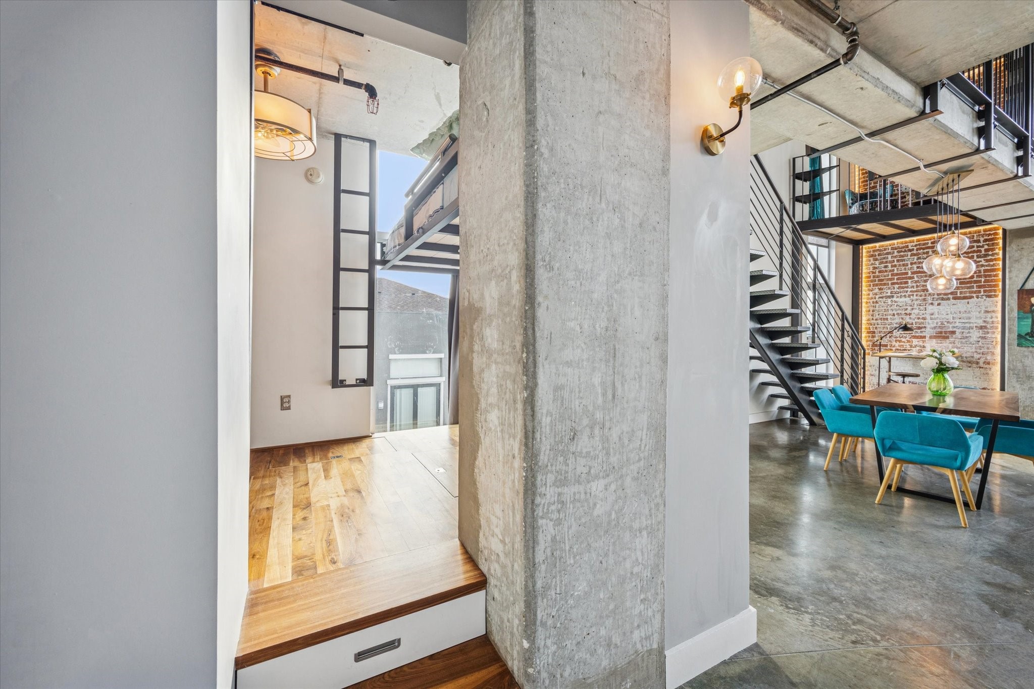 2000 Bagby Street, Unit 5400 Houston, TX 77002 - Photo 15 of 47 Stepping into the bonus room, showcasing the tall window that fills the space with natural light. In addition, built-in storage drawers tucked neatly under the steps, adding both function and extra storage space.