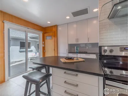 a kitchen with a sink appliances and cabinets