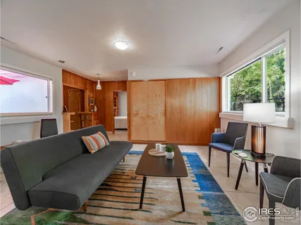 a living room with furniture and a rug