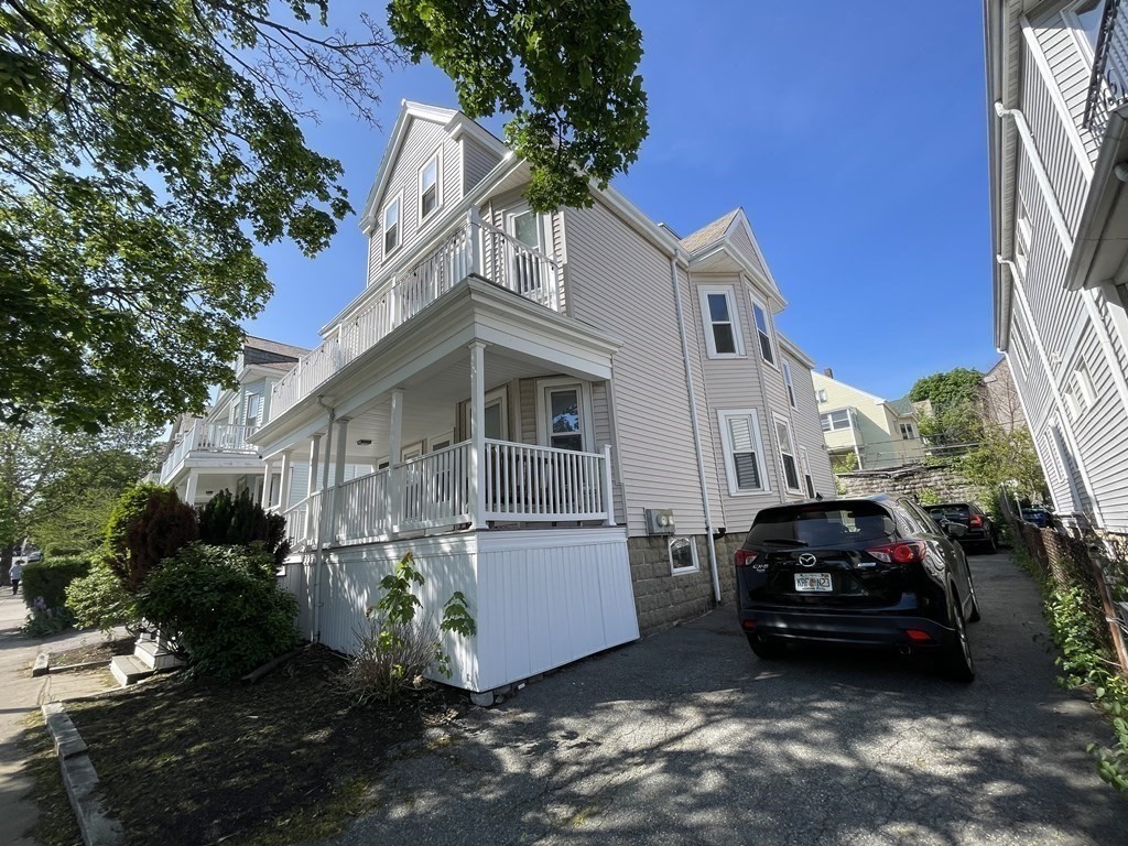 1049 Broadway, Unit 1 Somerville, MA 02144 - Photo 1 of 1 a car parked in front of a house