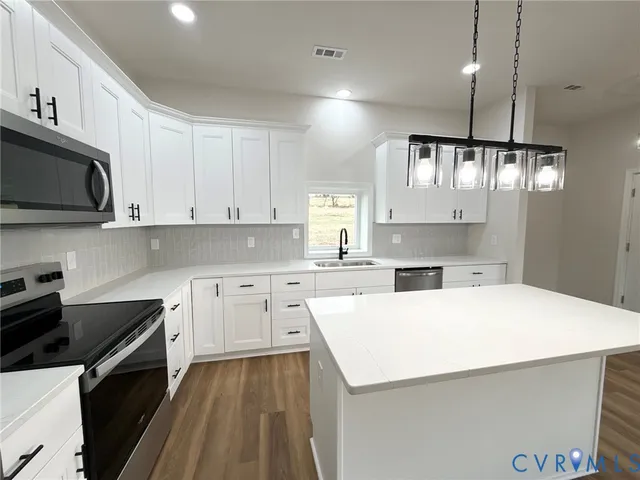 a kitchen with a sink a stove and cabinets