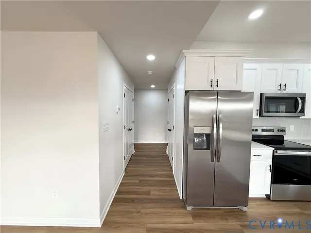 a kitchen with stainless steel appliances a refrigerator and a stove