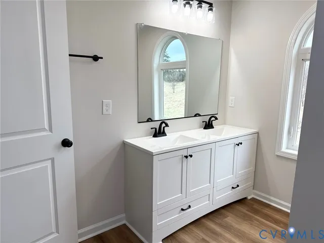 a bathroom with a double vanity sink and a mirror