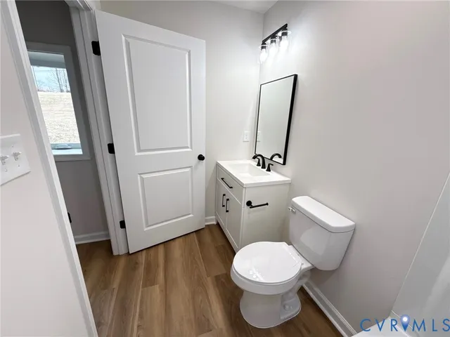 a white toilet sitting next to a bathroom sink