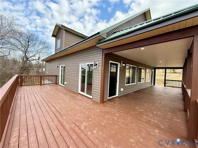 a view of backyard with large trees and wooden floor