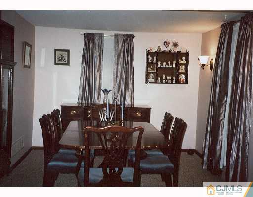 113 New Brooklyn Road Edison, NJ 08817 - Photo 3 of 8 a view of a dining room with furniture and chandelier
