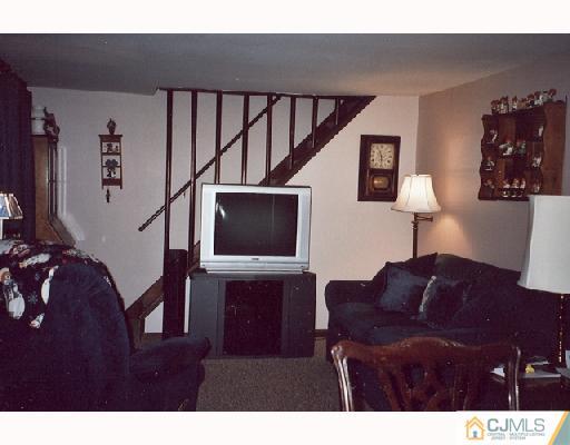 113 New Brooklyn Road Edison, NJ 08817 - Photo 5 of 8 a living room with furniture and a flat screen tv