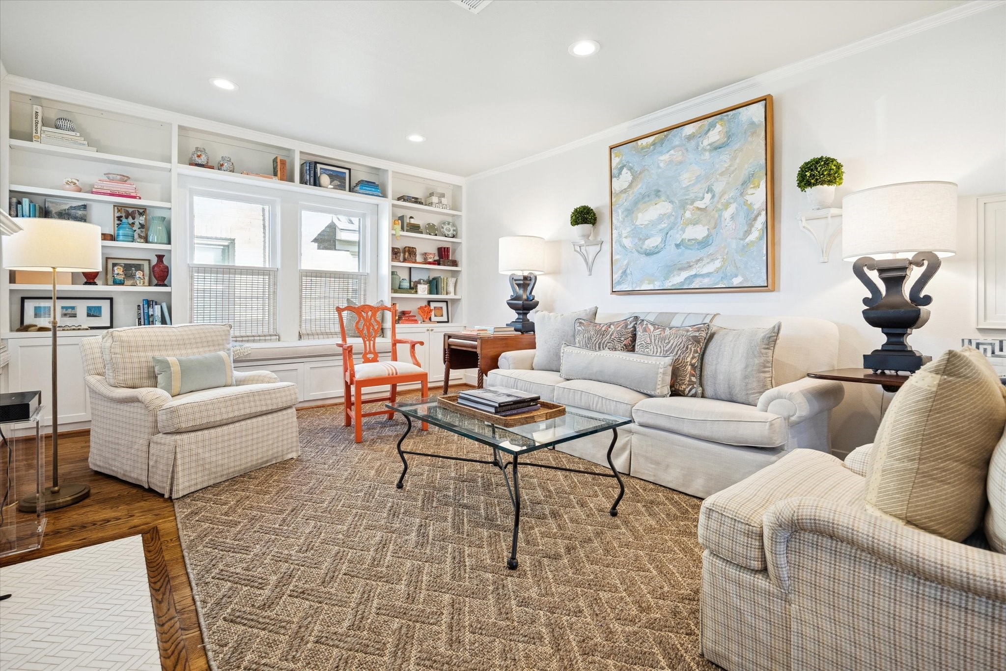 2109 Colquitt Street Houston, TX 77098 - Photo 5 of 28 The living room showcases the seamless layout, abundant natural light, and built-in shelving flanking the windows.