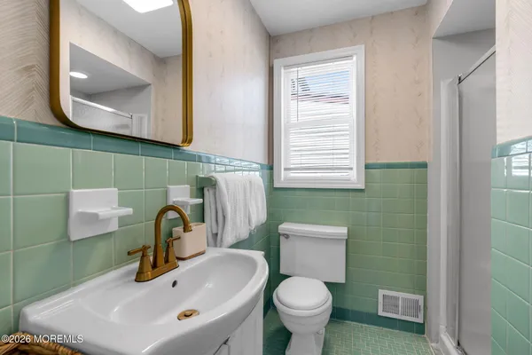 a bathroom with a sink toilet and mirror