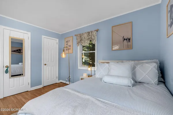 a bedroom with a large bed and a window