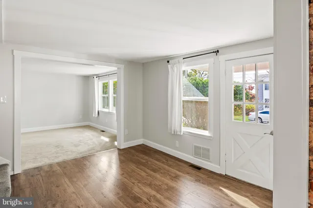 an empty room with windows and closet