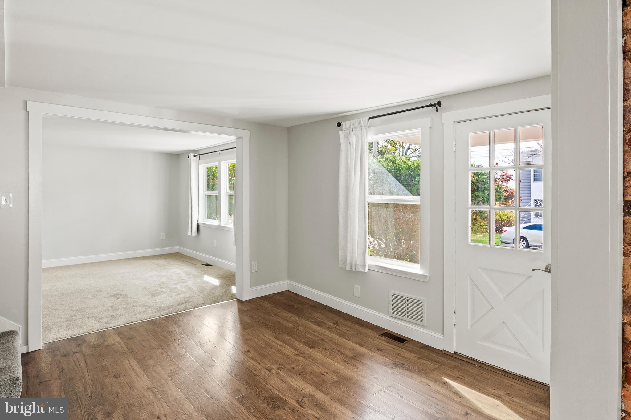 2201 Alvin Avenue Baltimore, MD 21228 - Photo 11 of 39 an empty room with wooden floor and windows