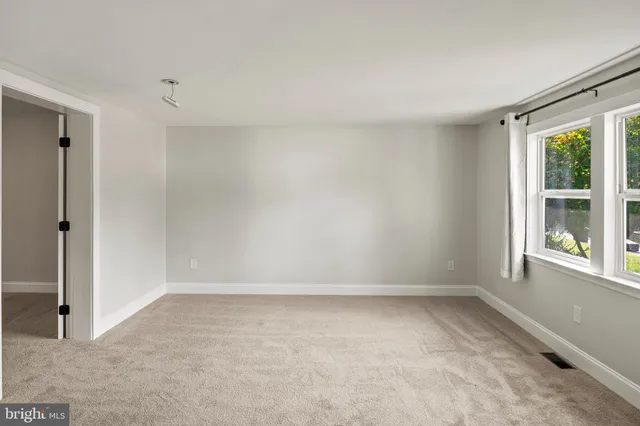 a view of a kitchen cabinets and a refrigerator