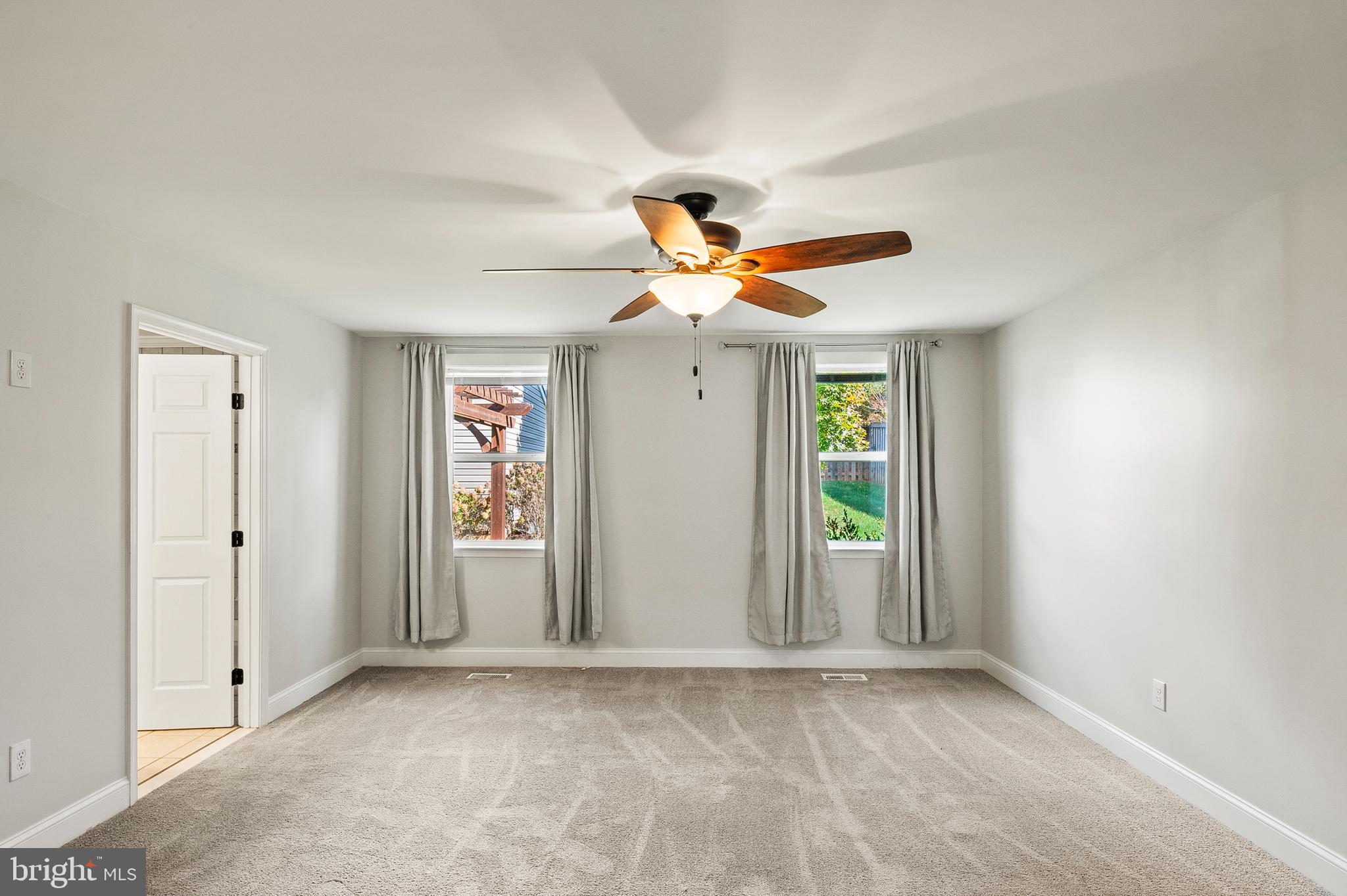2201 Alvin Avenue Baltimore, MD 21228 - Photo 15 of 39 an empty room with windows and fan