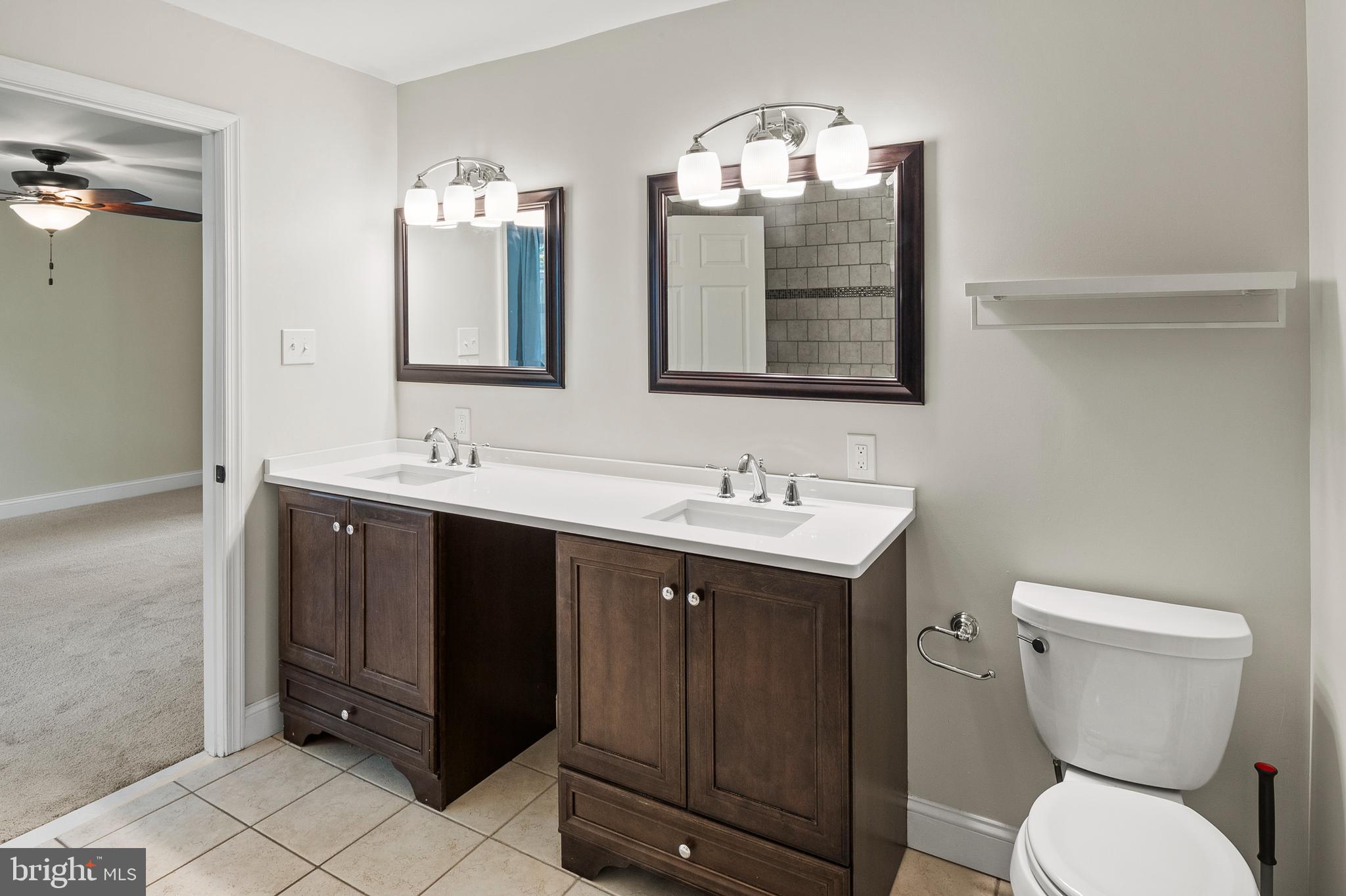 2201 Alvin Avenue Baltimore, MD 21228 - Photo 20 of 39 a bathroom with a toilet sink and mirror