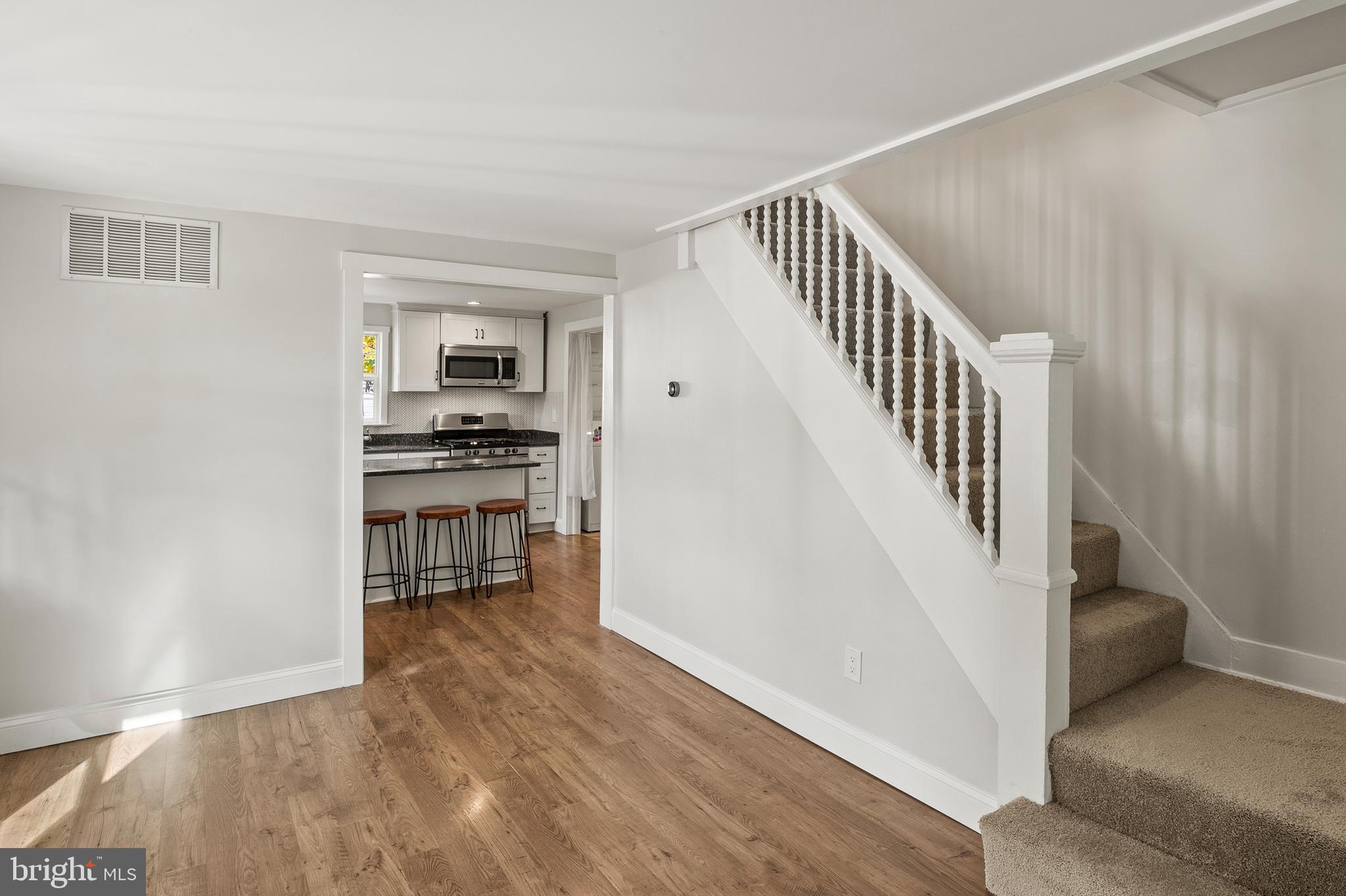 2201 Alvin Avenue Baltimore, MD 21228 - Photo 23 of 39 a view of a hallway with wooden floor and dining room