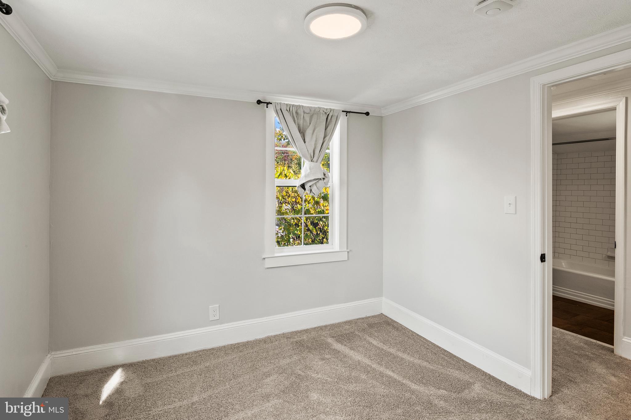 2201 Alvin Avenue Baltimore, MD 21228 - Photo 27 of 39 wooden floor in an empty room with a window