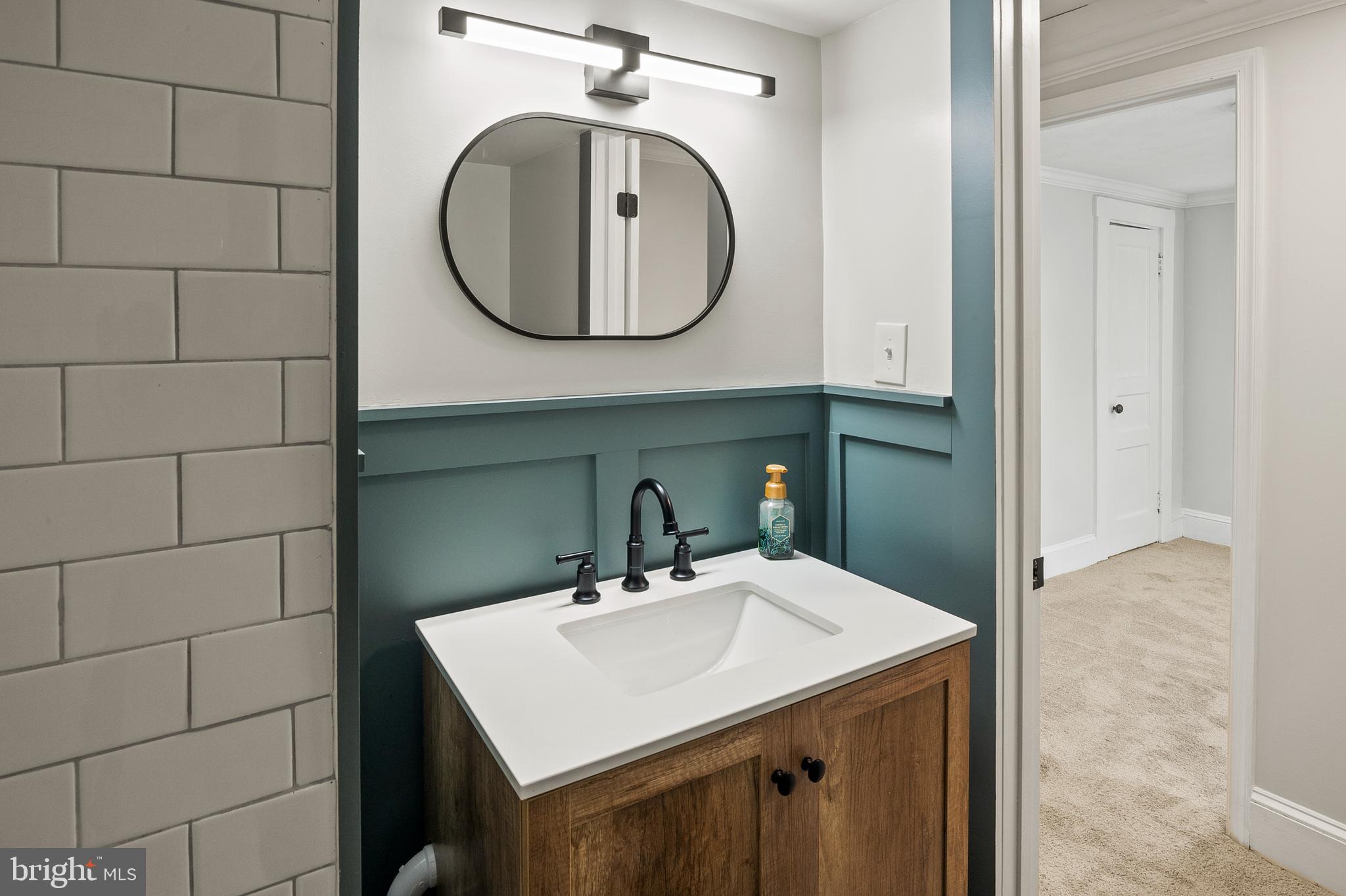 2201 Alvin Avenue Baltimore, MD 21228 - Photo 29 of 39 a bathroom with a sink and a mirror
