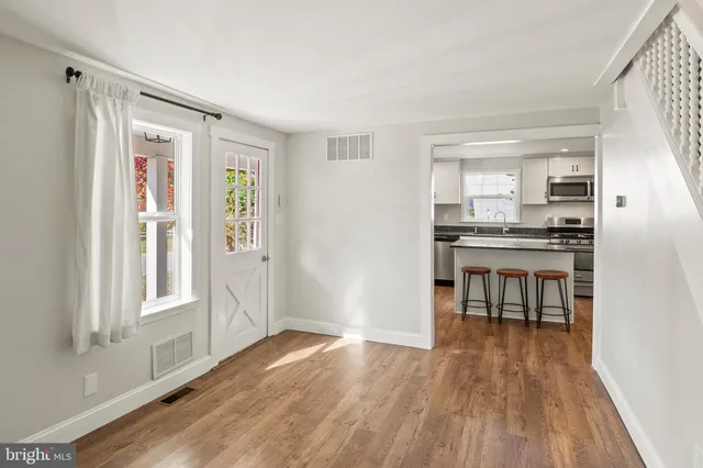a kitchen with stainless steel appliances granite countertop a stove a sink and a white cabinets