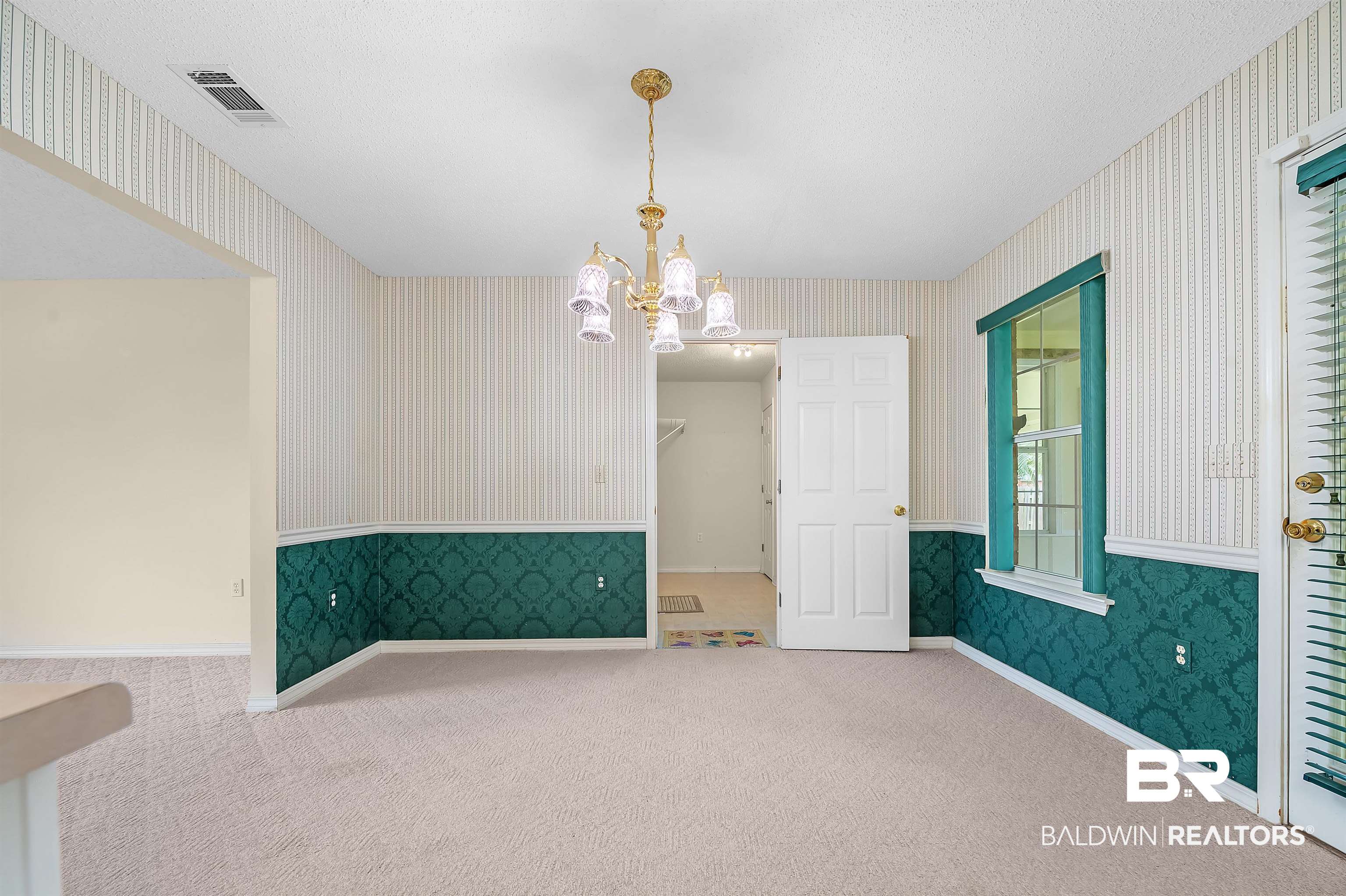1502 Mulberry Lane Foley, AL 36535 - Photo 18 of 45 Unfurnished room with carpet flooring and a chandelier