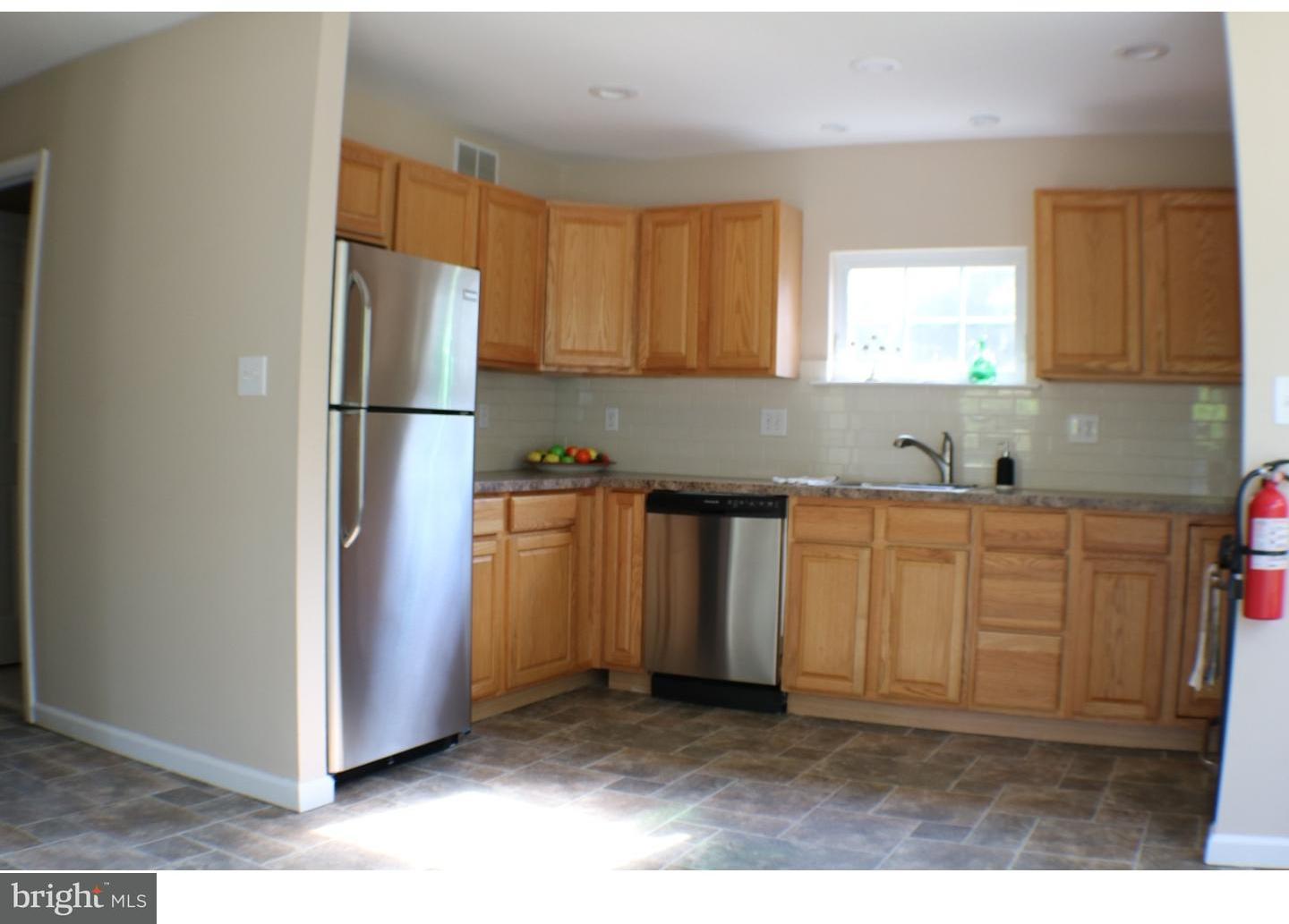 437 Almonesson Road Blackwood, NJ 08012 - Photo 11 of 17 a kitchen with granite countertop a refrigerator a sink and white cabinets
