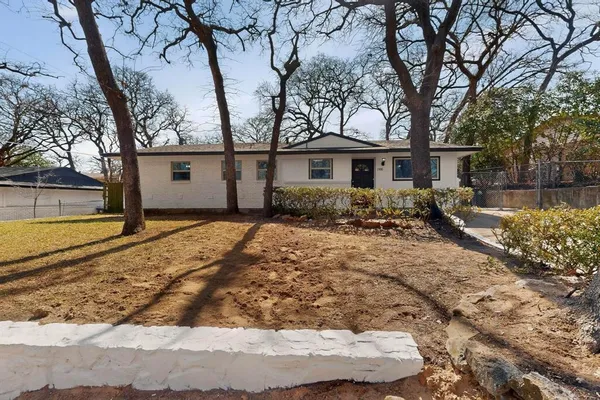 a view of a house with a yard covered in snow