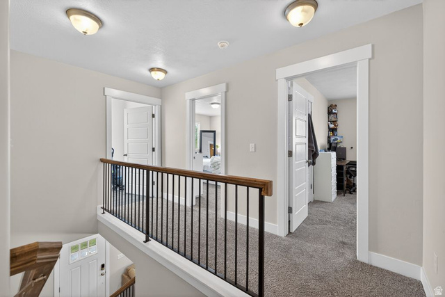 412 McClellan Court Provo, UT 84601 - Photo 19 of 20 Corridor featuring carpet flooring and an upstairs landing