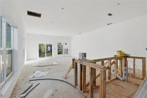 a view of a livingroom with furniture and staircase