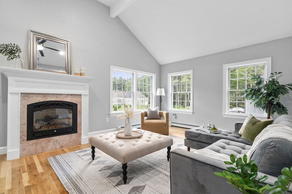 11 Fort Pond Road Acton, MA 01720 - Photo 11 of 40 a living room with furniture a fireplace and a table