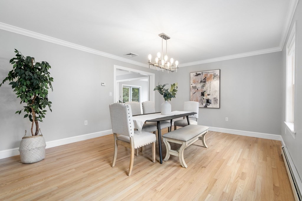 11 Fort Pond Road Acton, MA 01720 - Photo 14 of 40 a view of a dining room with furniture wooden floor and chandelier