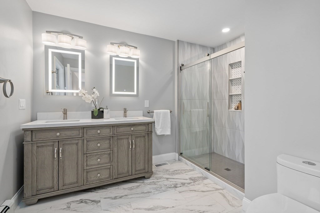 11 Fort Pond Road Acton, MA 01720 - Photo 18 of 40 a bathroom with a double vanity sink mirror and shower