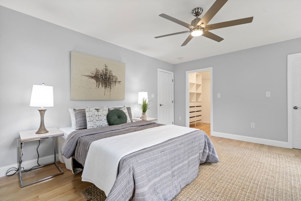 11 Fort Pond Road Acton, MA 01720 - Photo 20 of 40 a bedroom with a large bed and a chandelier