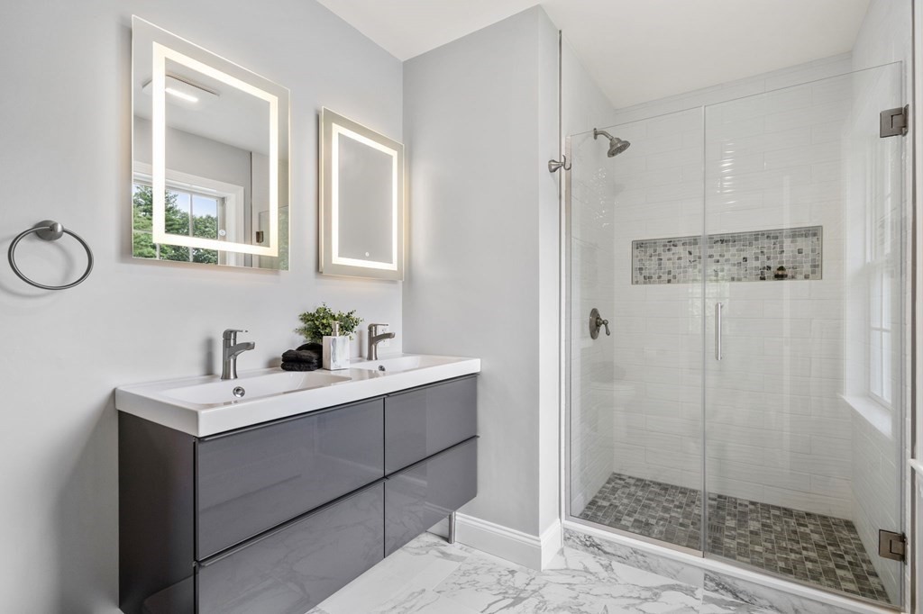 11 Fort Pond Road Acton, MA 01720 - Photo 22 of 40 a bathroom with a sink a mirror a vanity and a shower