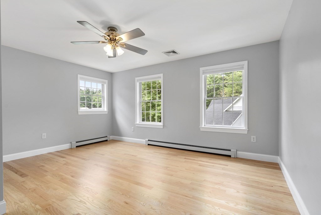 11 Fort Pond Road Acton, MA 01720 - Photo 24 of 40 a view of an empty room with wooden floor and a window