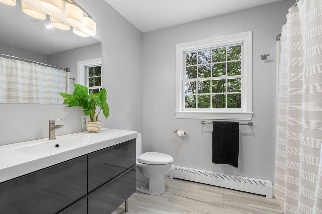 11 Fort Pond Road Acton, MA 01720 - Photo 28 of 40 a bathroom with a sink toilet and shower
