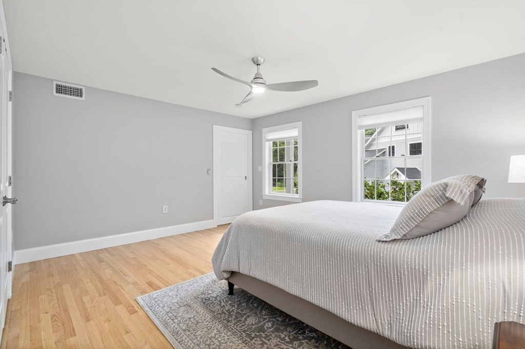 11 Fort Pond Road Acton, MA 01720 - Photo 30 of 40 a bedroom with a large bed and wooden floor