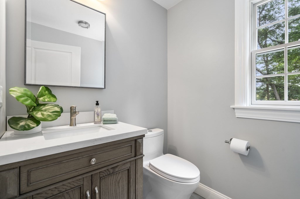 11 Fort Pond Road Acton, MA 01720 - Photo 33 of 40 a bathroom with a granite countertop toilet sink and mirror