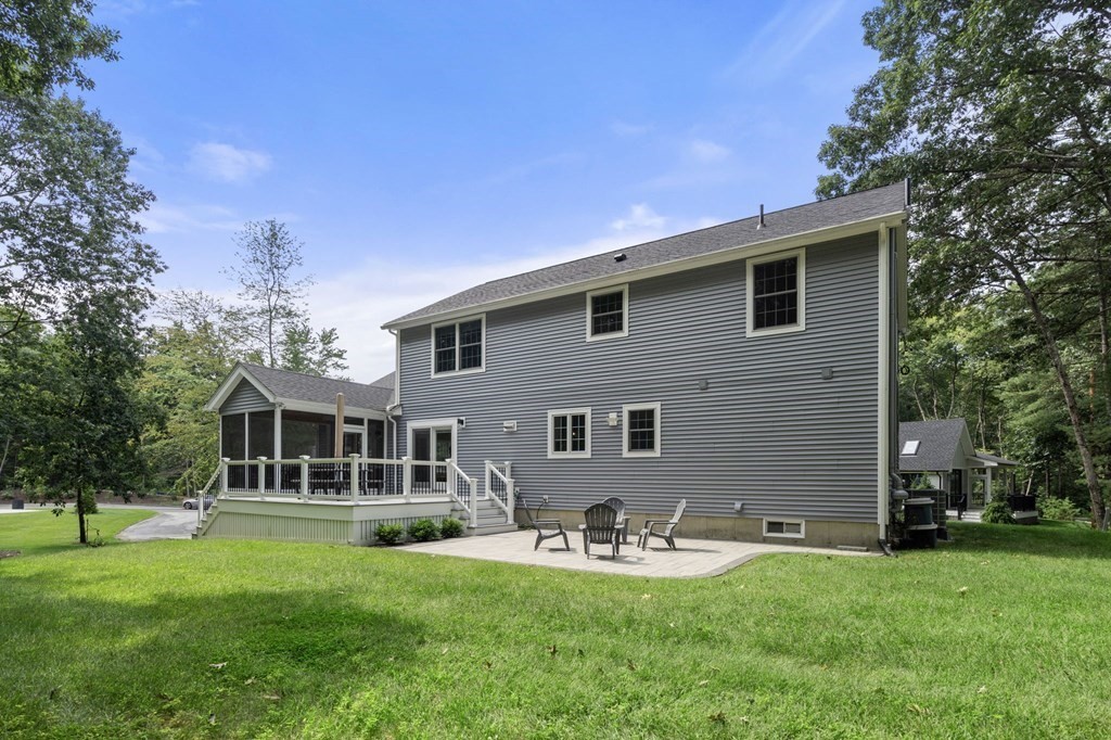 11 Fort Pond Road Acton, MA 01720 - Photo 35 of 40 a front view of a house with yard and green space