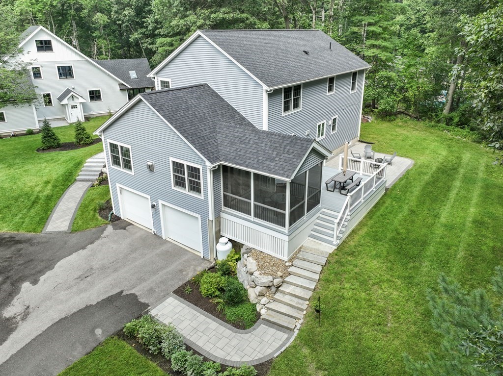 11 Fort Pond Road Acton, MA 01720 - Photo 36 of 40 a aerial view of a house with a yard table and chairs
