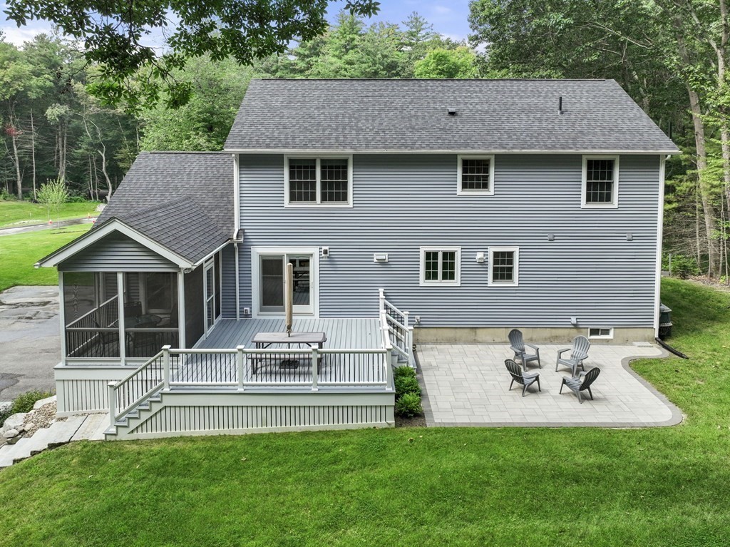 11 Fort Pond Road Acton, MA 01720 - Photo 37 of 40 a front view of a house with a garden and yard