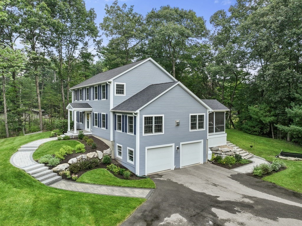 11 Fort Pond Road Acton, MA 01720 - Photo 5 of 40 a front view of a house with a yard and garage
