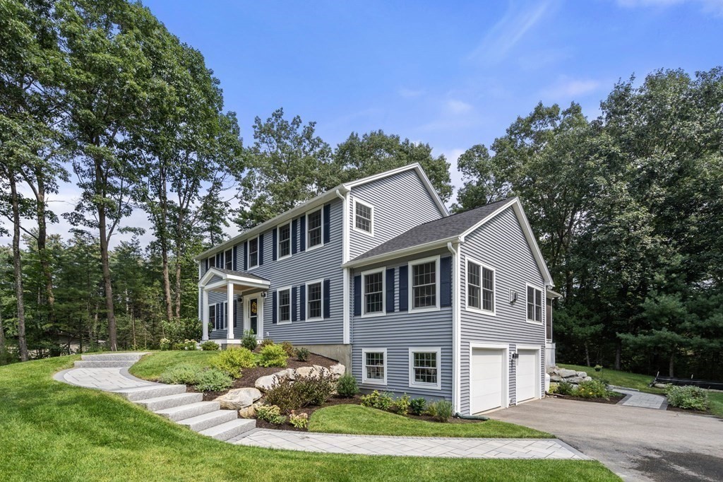 11 Fort Pond Road Acton, MA 01720 - Photo 6 of 40 a front view of a house with a yard