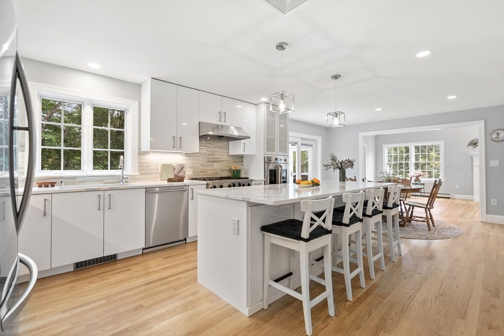11 Fort Pond Road Acton, MA 01720 - Photo 8 of 40 a kitchen with a dining table chairs and white cabinets