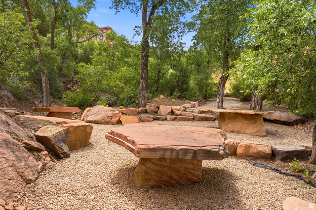 3355 Santa Fe Road Park City, UT 84098 - Photo 45 of 45 Landscaped outdoor area featuring a gravel ground cover, mature trees, and large natural stone elements